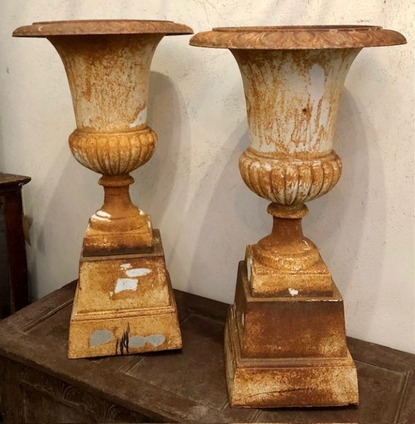A pair of 19th century cast iron Campanula garden urns on stands.